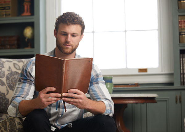 A man reading the NET Bible