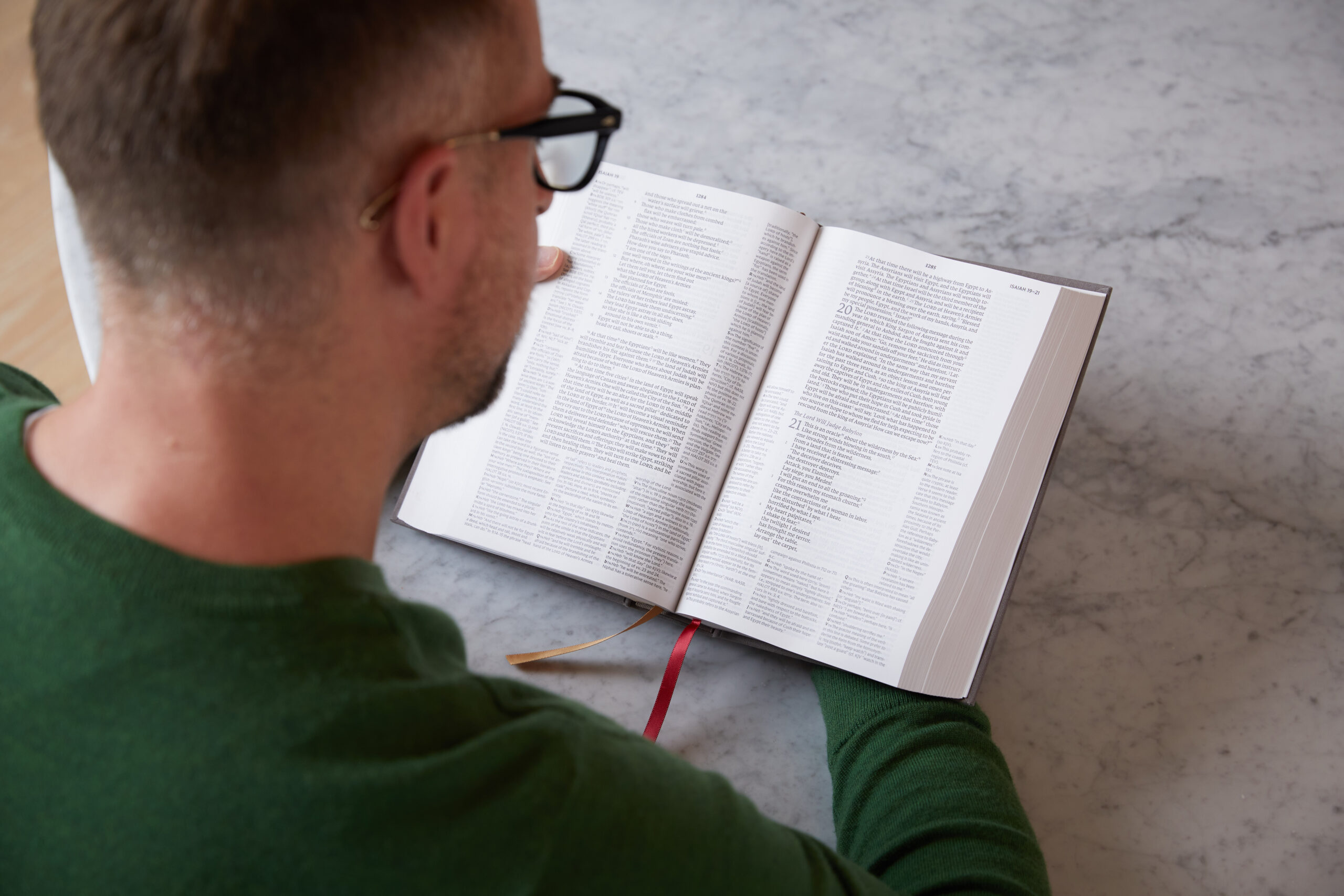 A man reading a NET Bible